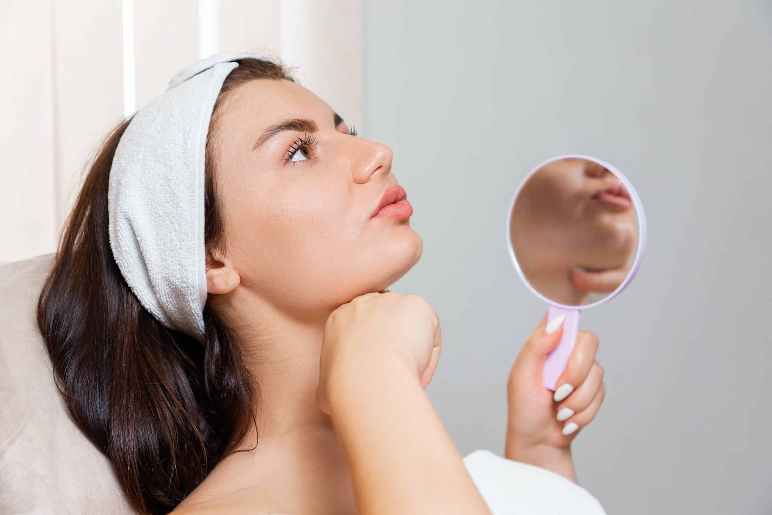Thread,Lifting.,A,Young,Beautiful,Woman,Holds,A,Mirror,And